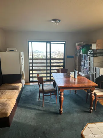 a view of a dining room with furniture and window