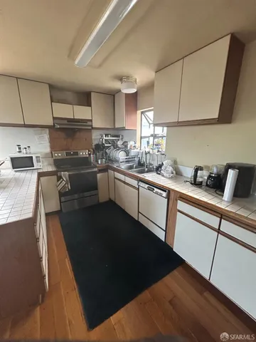 a kitchen with a sink stove and cabinets