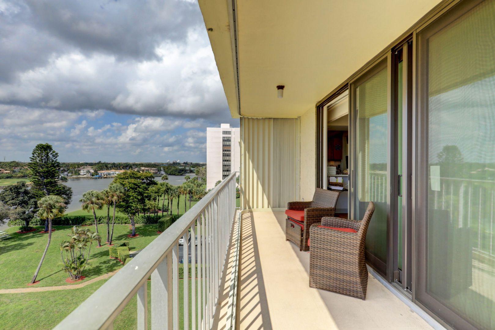 336 Golfview Road, Unit 601 North Palm Beach, FL 33408 - Photo 11 of 28 a balcony view with couple of chairs and wooden floor