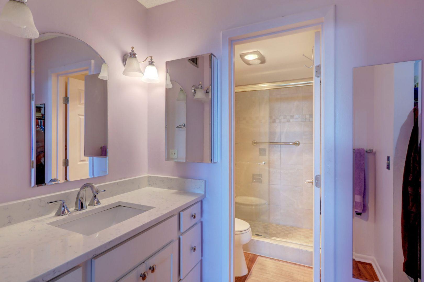 336 Golfview Road, Unit 601 North Palm Beach, FL 33408 - Photo 14 of 28 a bathroom with a granite countertop sink shower and a mirror
