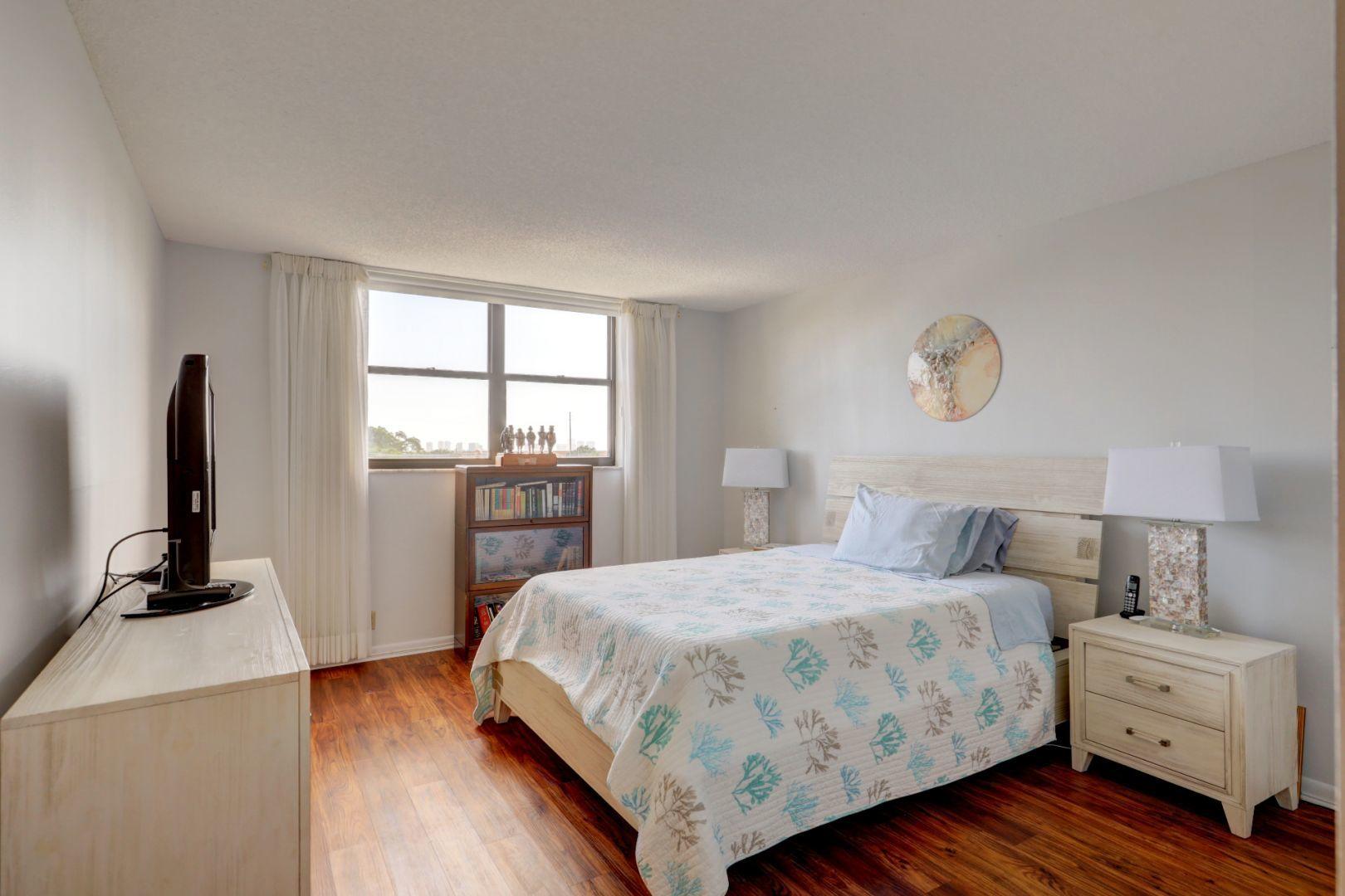 336 Golfview Road, Unit 601 North Palm Beach, FL 33408 - Photo 15 of 28 a bedroom with a bed and a flat screen tv