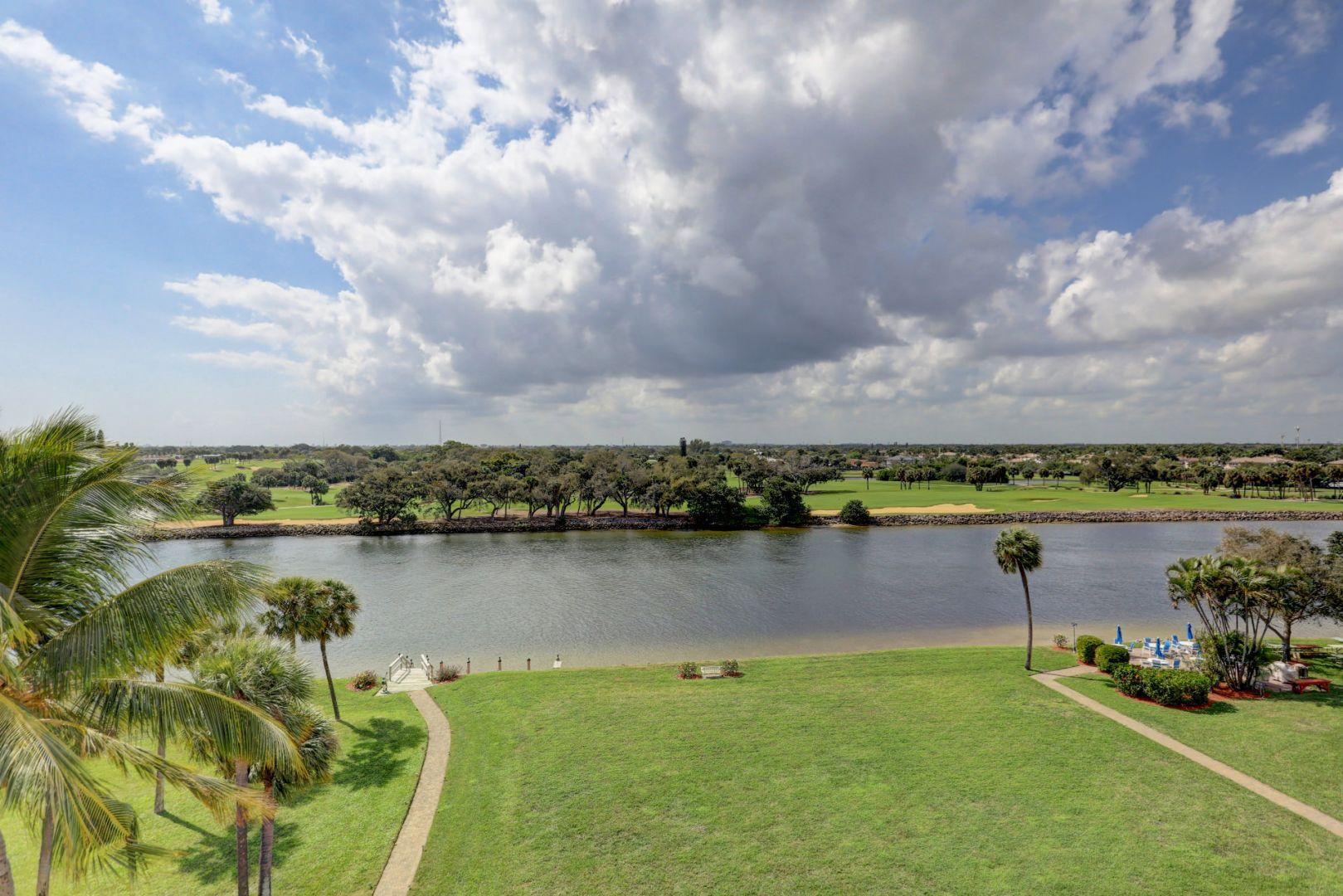 336 Golfview Road, Unit 601 North Palm Beach, FL 33408 - Photo 19 of 28 a view of a lake with a houses in the back