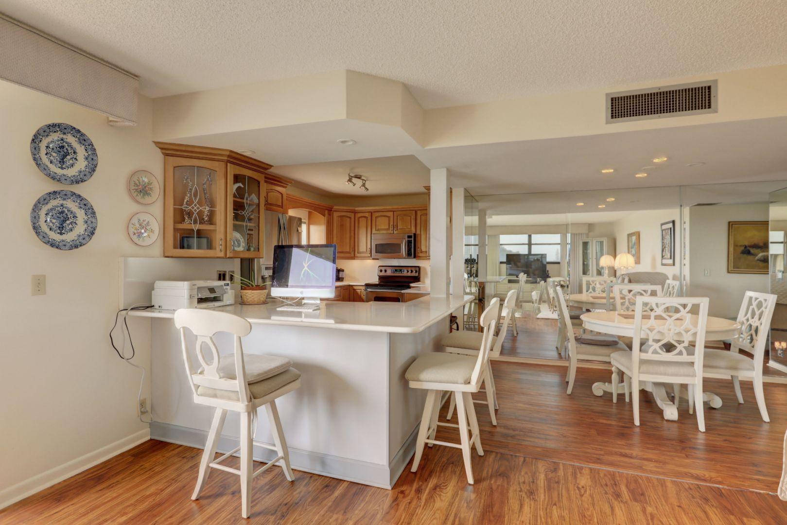 336 Golfview Road, Unit 601 North Palm Beach, FL 33408 - Photo 4 of 28 a view of a dining room with furniture and wooden floor