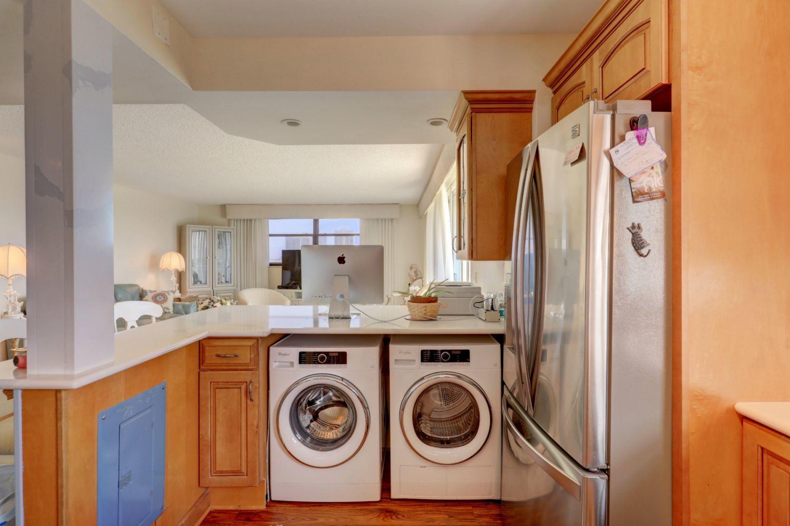 336 Golfview Road, Unit 601 North Palm Beach, FL 33408 - Photo 8 of 28 a view of a storage and utility room with a washer and dryer