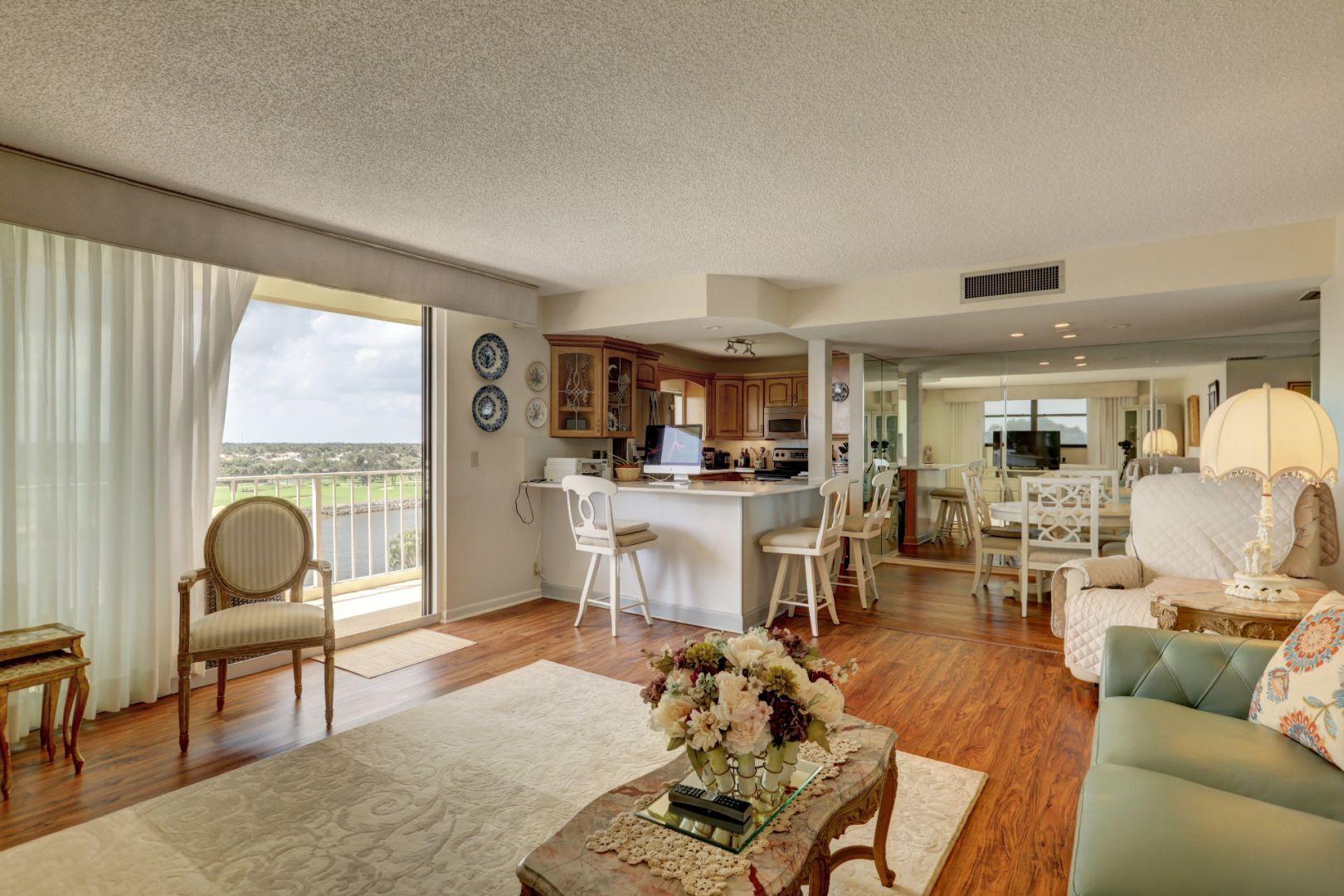 336 Golfview Road, Unit 601 North Palm Beach, FL 33408 - Photo 9 of 28 a living room with furniture a dining table and a large window