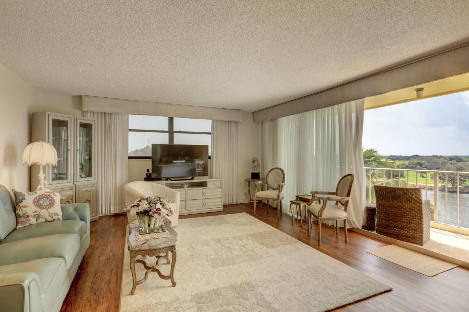 336 Golfview Road, Unit 601 North Palm Beach, FL 33408 - Photo 10 of 28 a living room with furniture and a large window