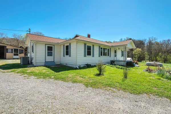 a view of an empty room with closet and a chandelier fan