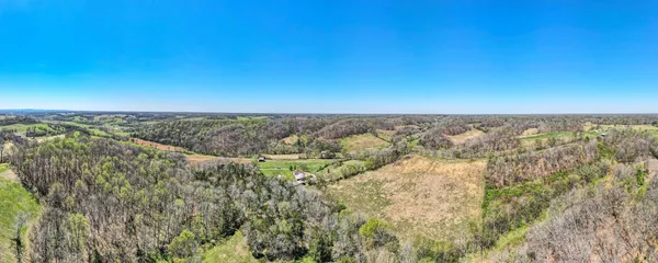 a view of a back yard of the house and a yard