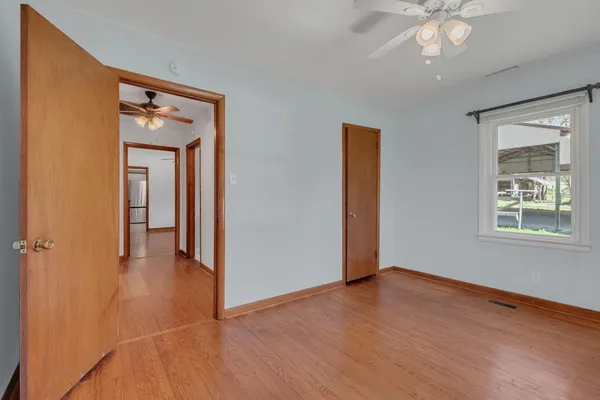 a view of a livingroom with a hardwood floor and a ceiling fan