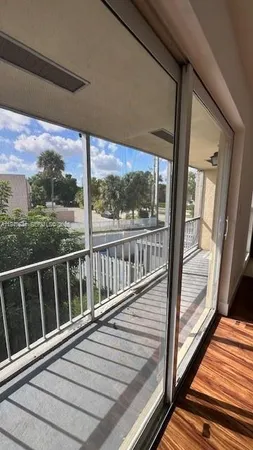 a view of balcony with wooden floor