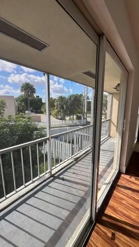 a view of balcony with wooden floor