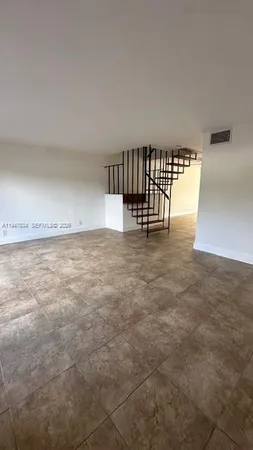 a view of an empty room with kitchen natural appliances