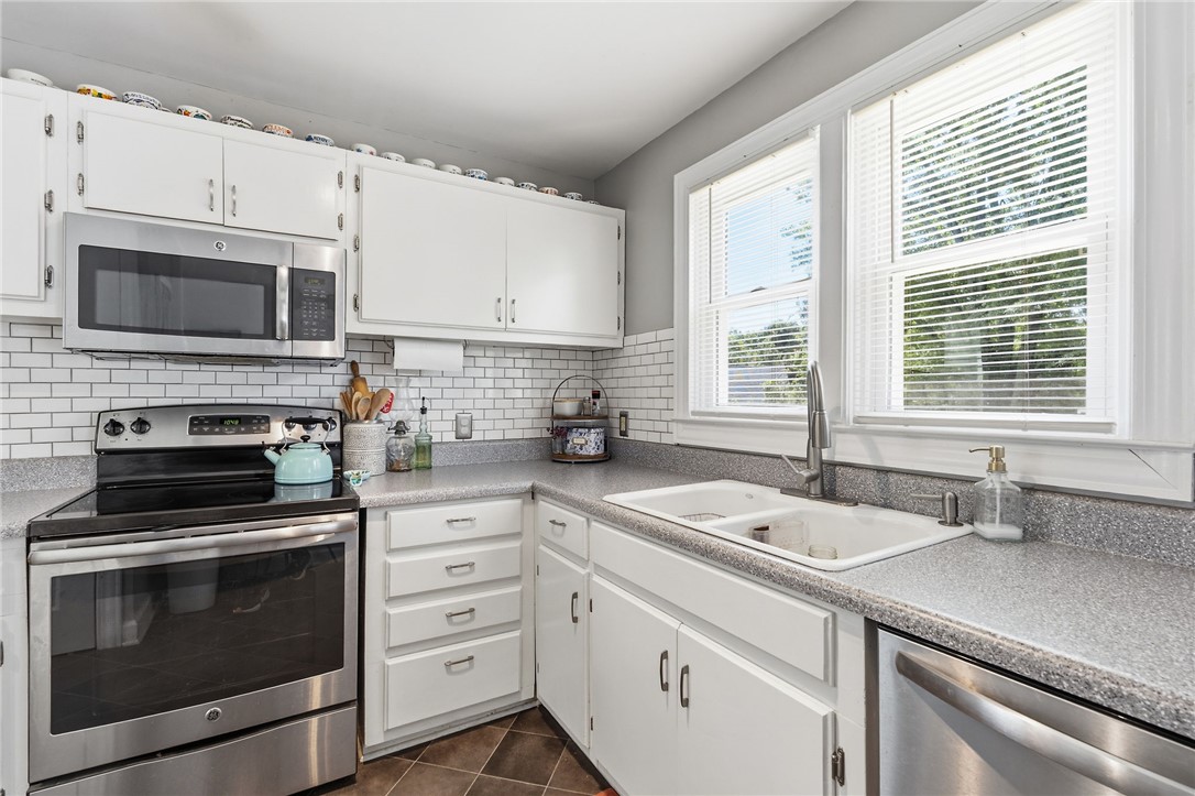 108 Tarrant Street Central, SC 29630 - Photo 17 of 42 A pristine kitchen features sleek stainless steel appliances, abundant cabinetry, and a bright window overlooking the sink.
