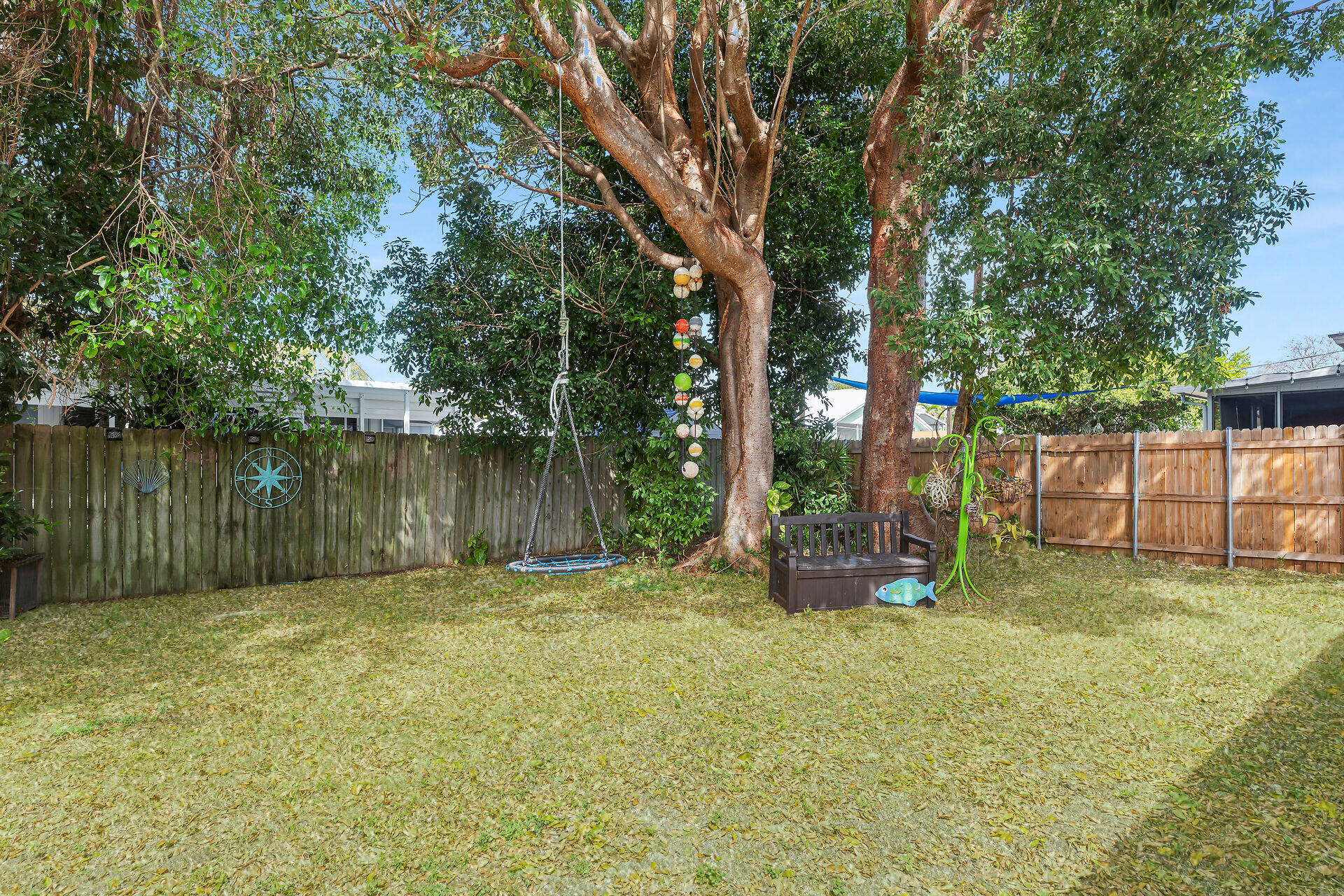 30 Jewfish Avenue Key Largo, FL 33037 - Photo 24 of 43 a backyard of a house with table and chairs