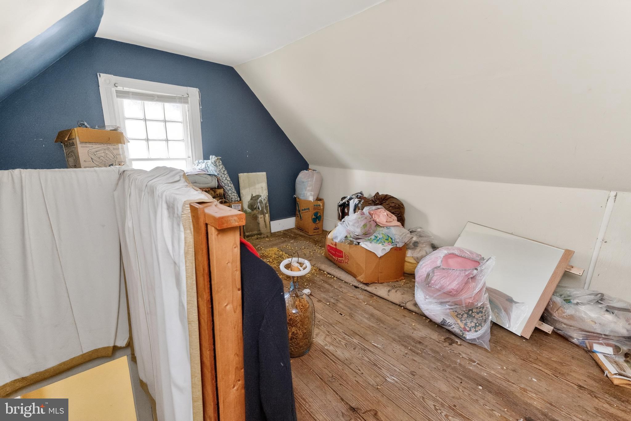 522 Market Street Denton, MD 21629 - Photo 11 of 49 a bedroom with a bed and wooden floor
