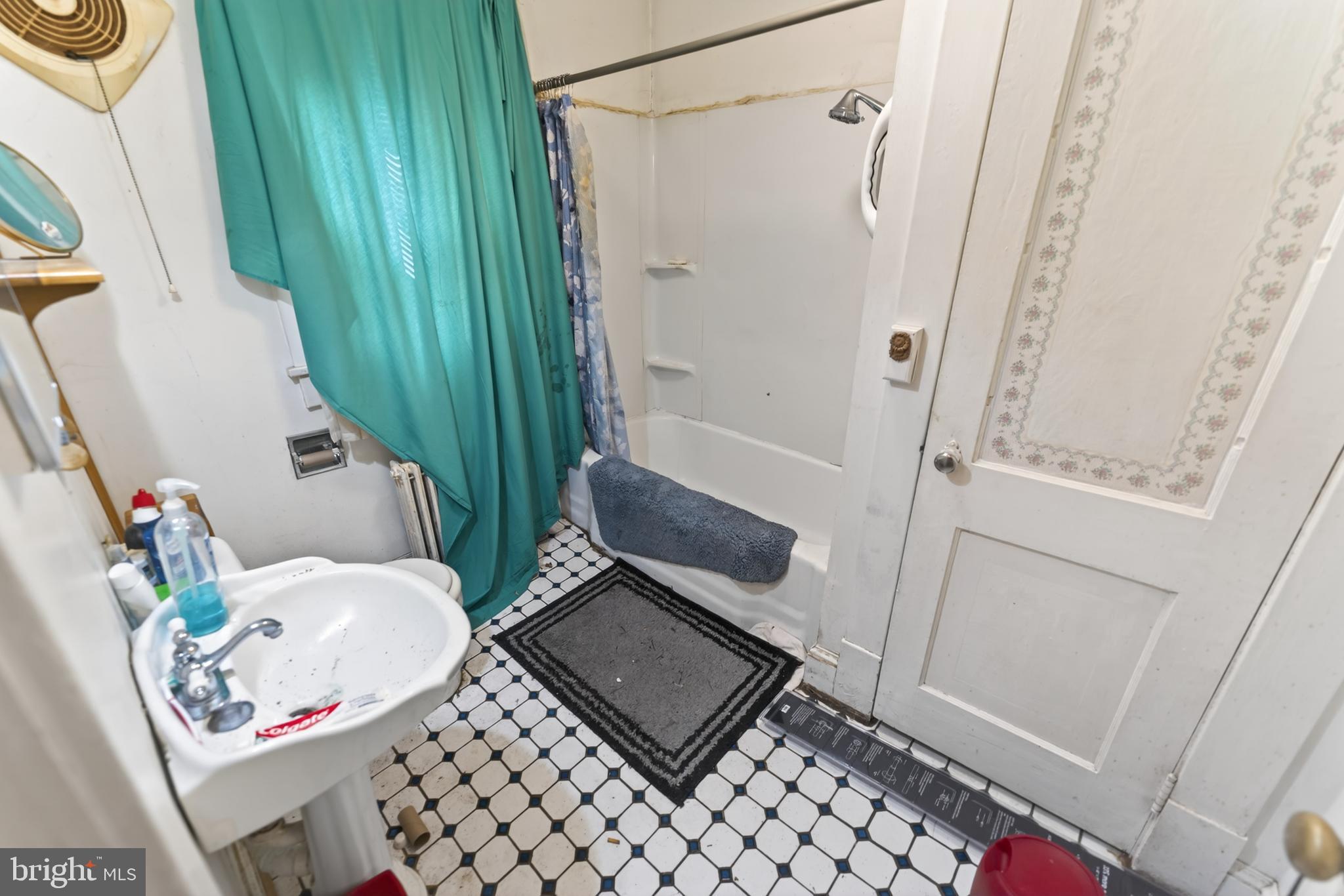 522 Market Street Denton, MD 21629 - Photo 32 of 49 a bathroom with a toilet and a shower curtain