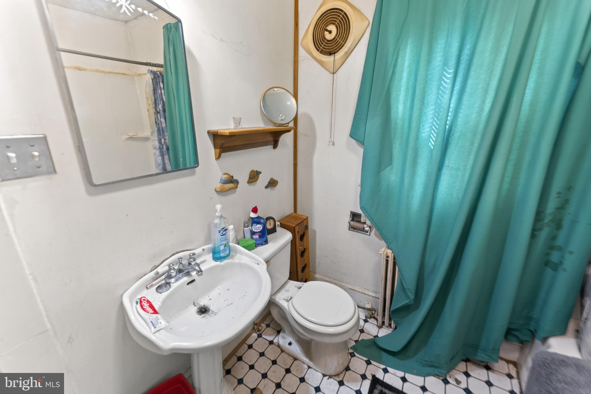 522 Market Street Denton, MD 21629 - Photo 33 of 49 a bathroom with a toilet sink and mirror