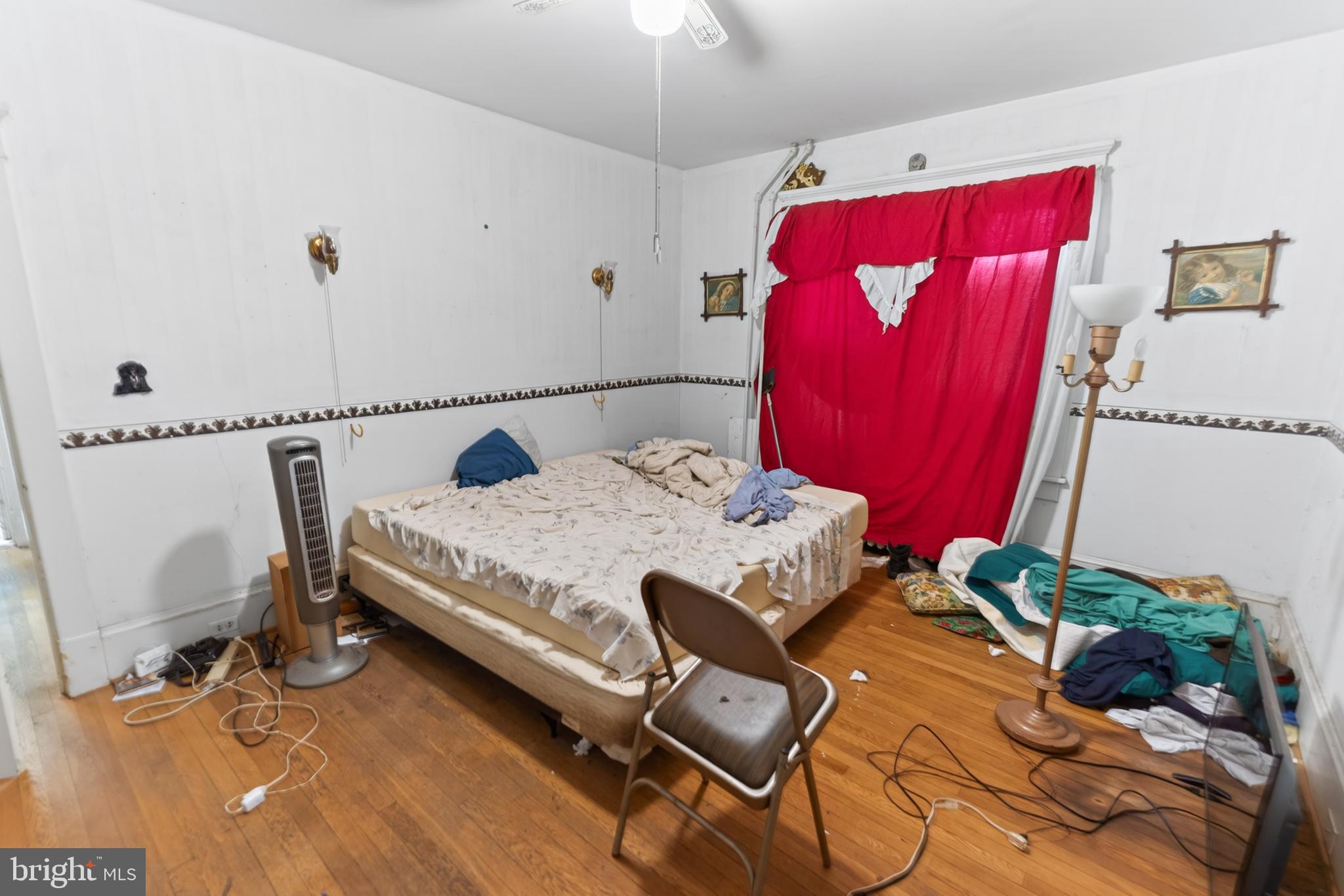 522 Market Street Denton, MD 21629 - Photo 35 of 49 a bedroom with a bed and a chair