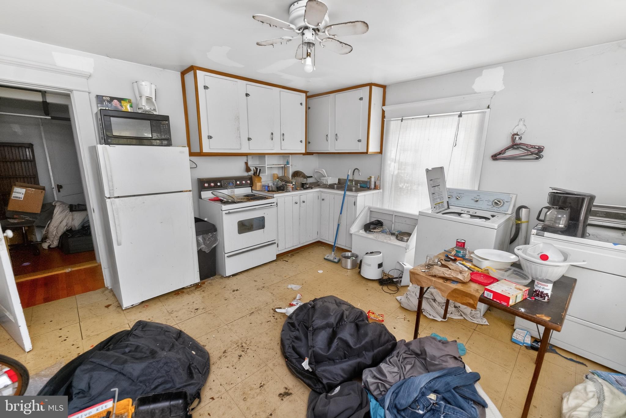 522 Market Street Denton, MD 21629 - Photo 44 of 49 a kitchen with a refrigerator sink and cabinets