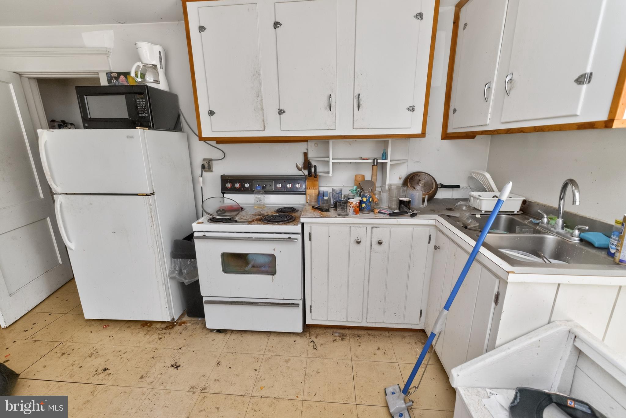 522 Market Street Denton, MD 21629 - Photo 45 of 49 a kitchen with a sink a stove and cabinets