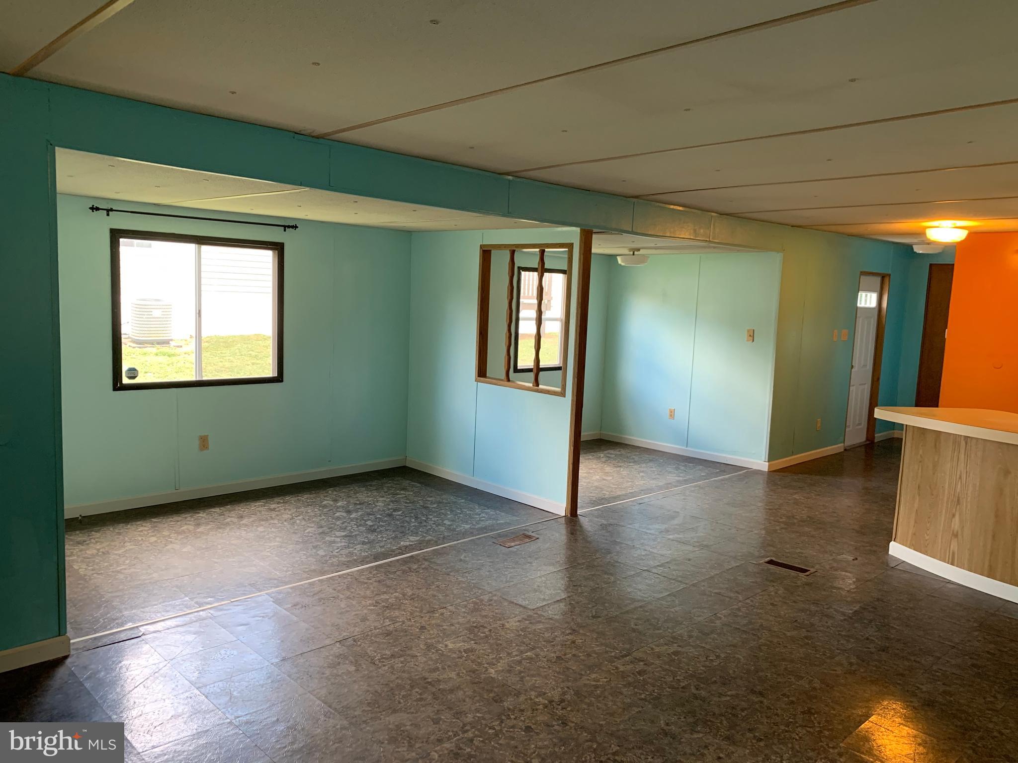901 South Spring Garden Street, Unit 67 Carlisle, PA 17015 - Photo 7 of 26 a view of an empty room with window and wooden floor