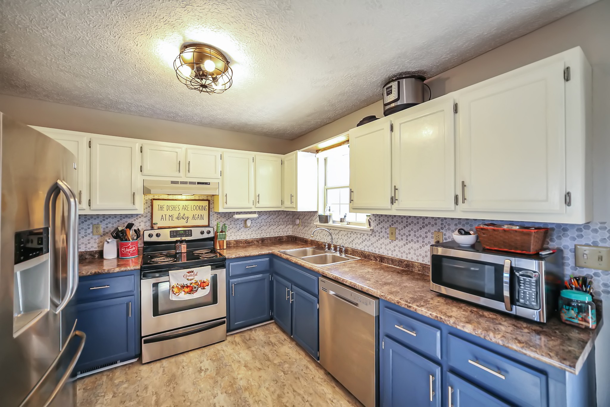 806 Old Gallatin Road Portland, TN 37148 - Photo 6 of 16 a kitchen with kitchen island granite countertop a sink stove and microwave