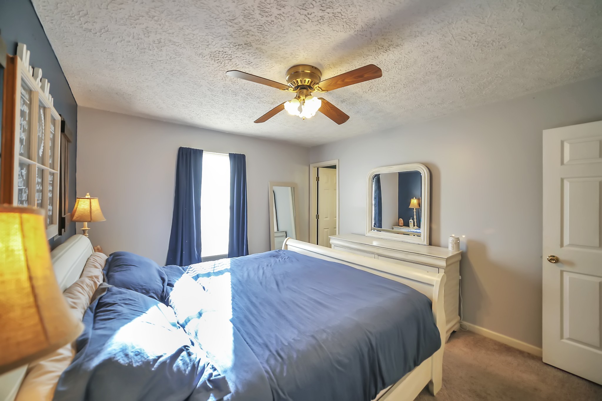 806 Old Gallatin Road Portland, TN 37148 - Photo 8 of 16 a bedroom with a bed and a chandelier