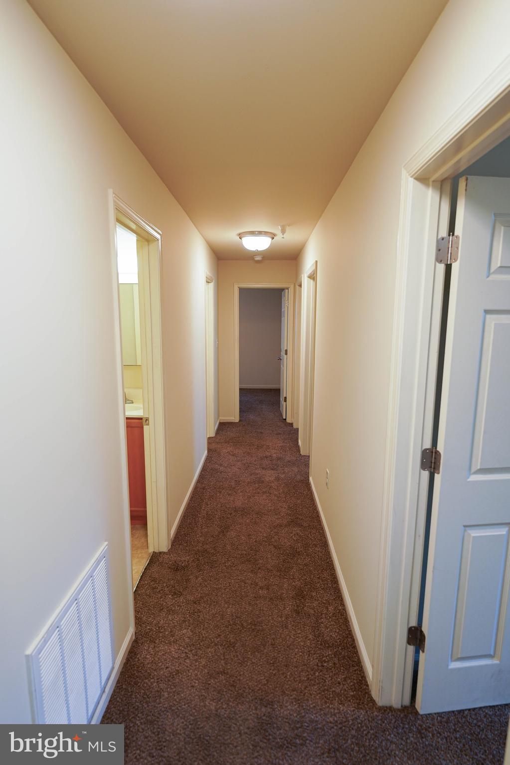 30630 Umes Boulevard, Unit V204 Princess Anne, MD 21853 - Photo 12 of 36 a view of a hallway with wooden floor