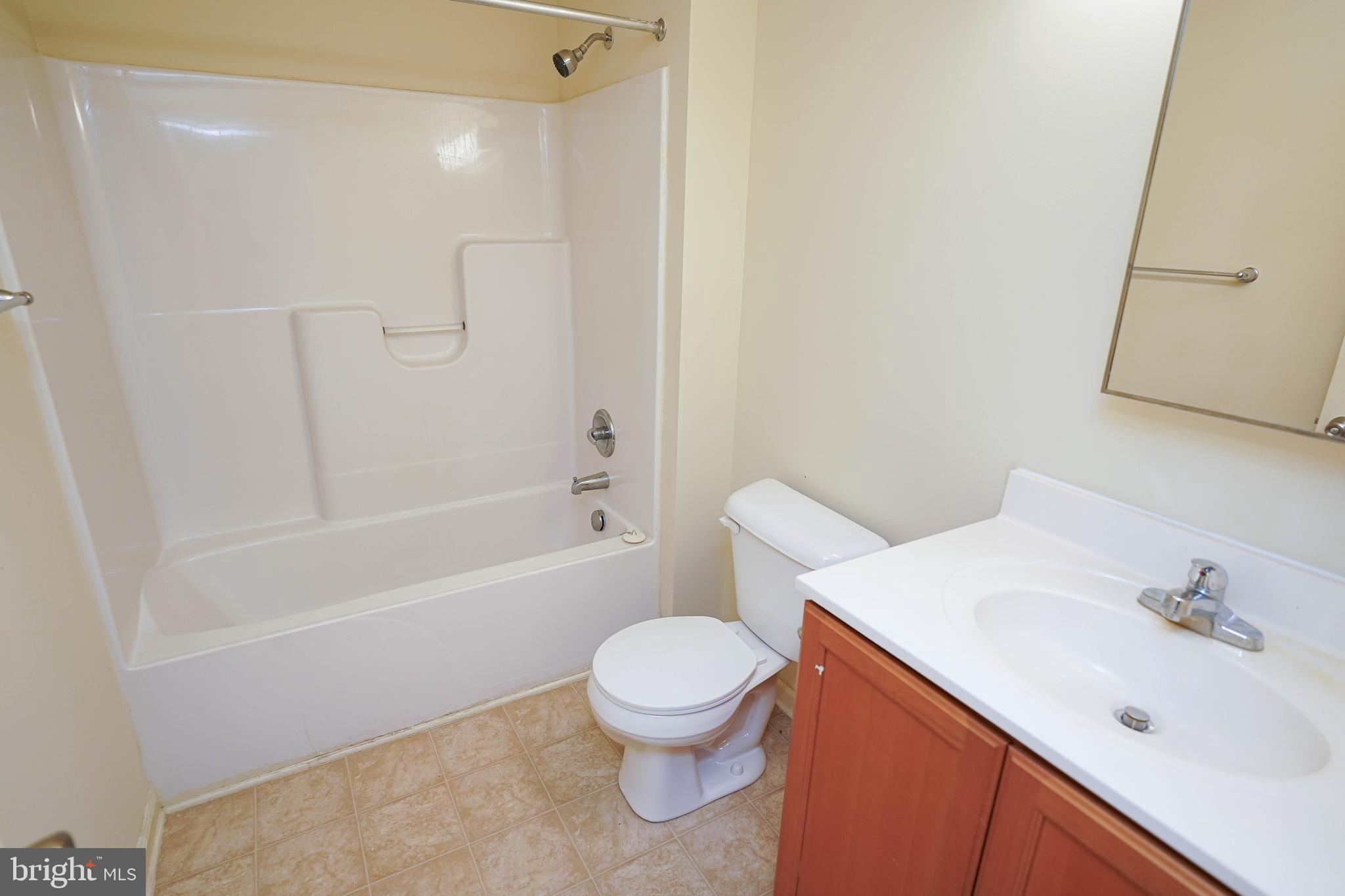 30630 Umes Boulevard, Unit V204 Princess Anne, MD 21853 - Photo 19 of 36 a bathroom with a sink a toilet and a bathtub