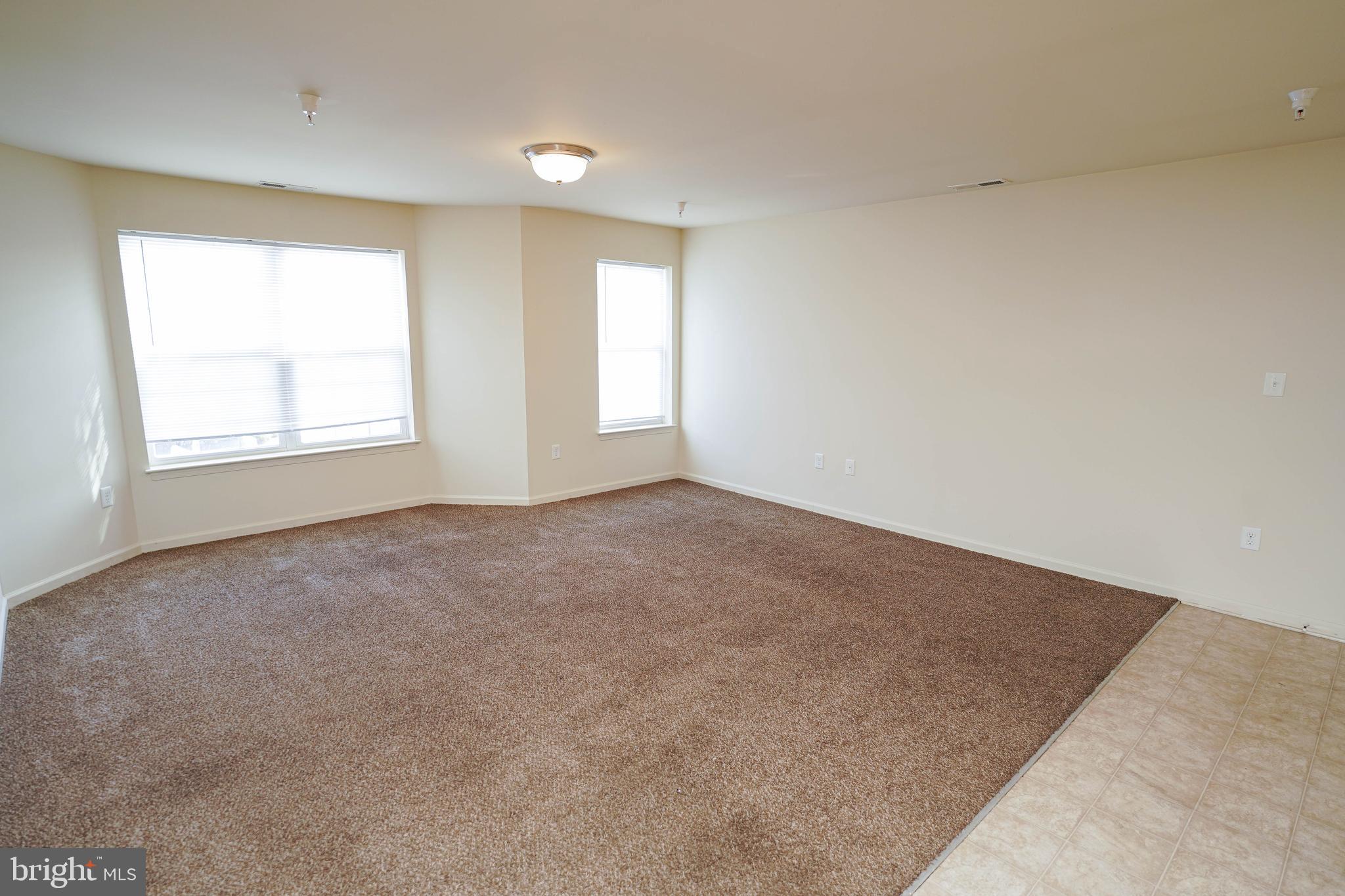 30630 Umes Boulevard, Unit V204 Princess Anne, MD 21853 - Photo 6 of 36 an empty room with windows