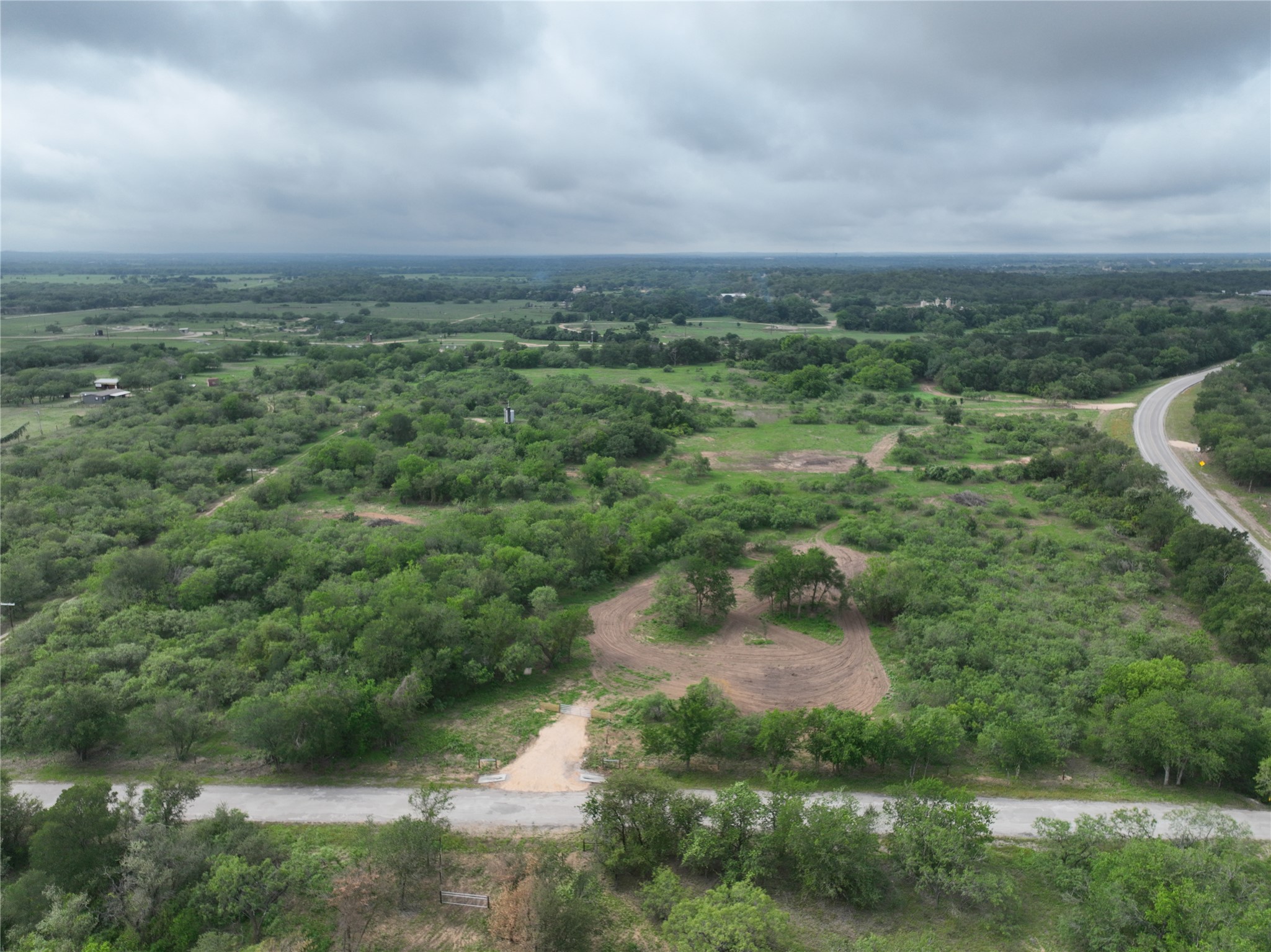 150 Pumper Road Luling, TX 78648 - Photo 1 of 24 Vast, verdant landscape offering a prime development opportunity with convenient road access.