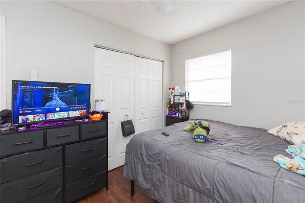 a bedroom with a bed table and a window