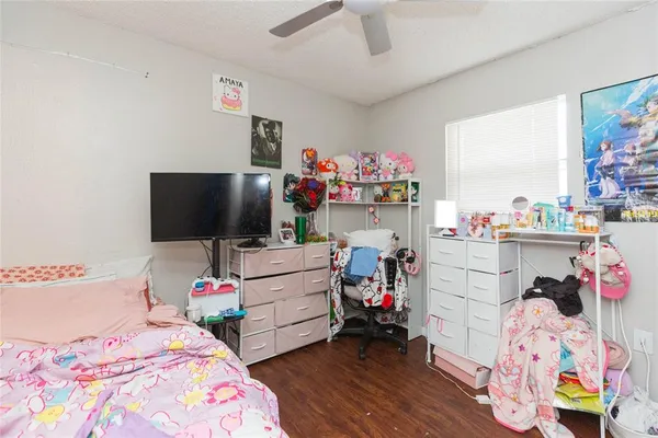 a bedroom with a bed a window and dresser
