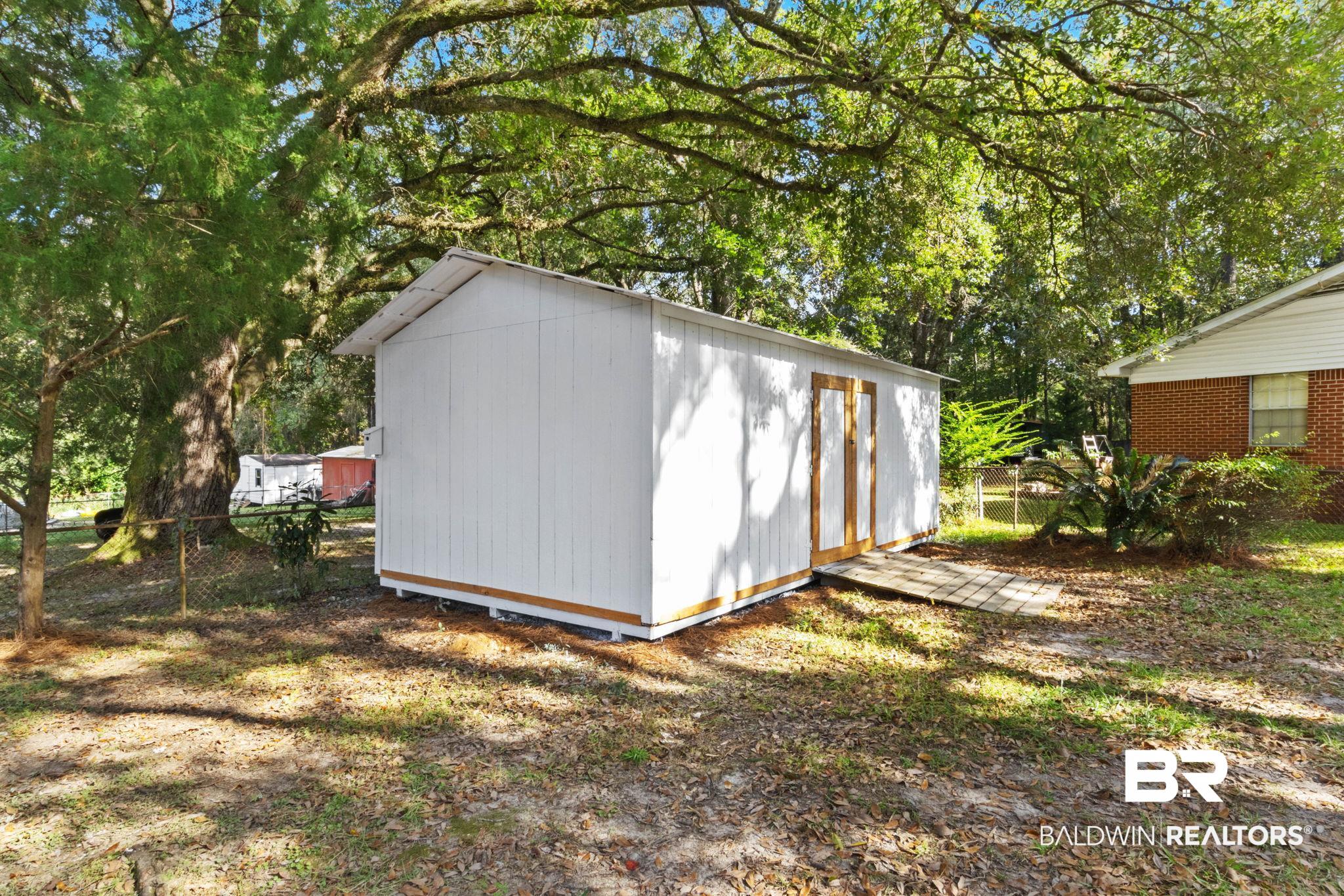 618 Pine Street Saraland, AL 36571 - Photo 35 of 41 View of shed featuring view of scattered trees