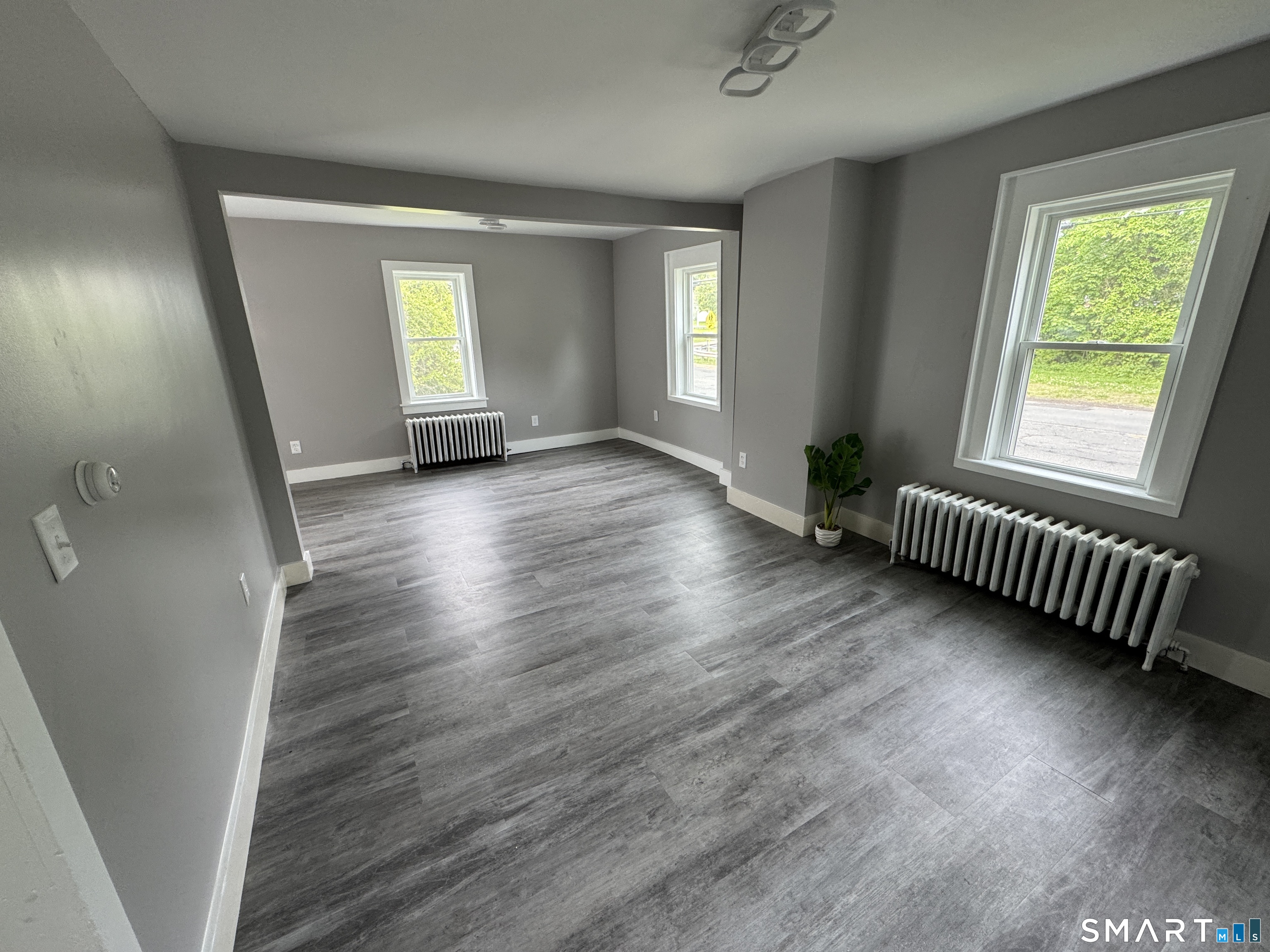 10 Center Street Windsor Locks, CT 06096 - Photo 17 of 25 an empty room with wooden floor and windows
