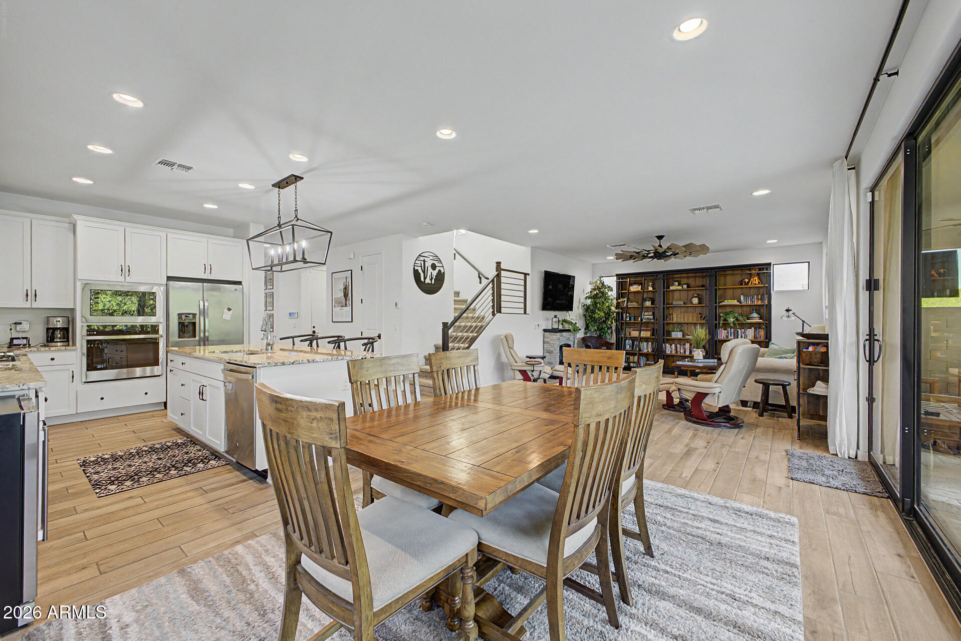 819 West Deer Creek Road Phoenix, AZ 85048 - Photo 19 of 76 an open kitchen with a table and chairs in it