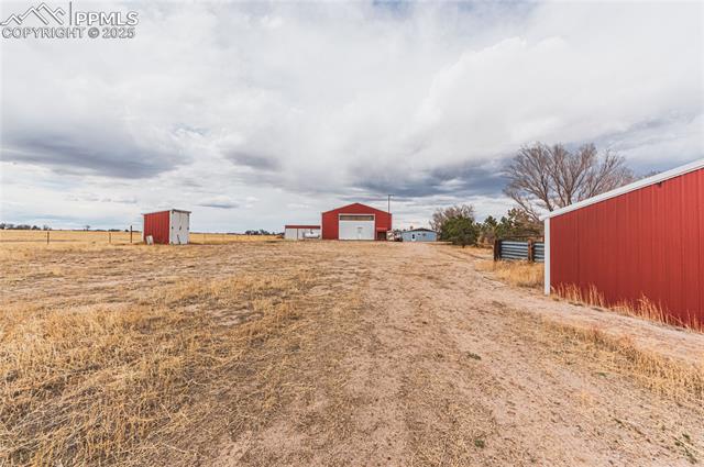 22885 Handle Road Calhan, CO 80808 - Photo 36 of 38 View of yard featuring an outbuilding, a garage, and driveway