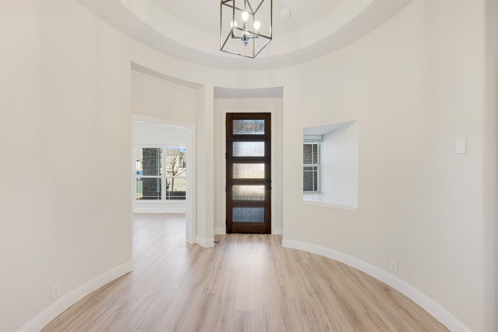 733 Seahawk Street Joshua, TX 76058 - Photo 5 of 35 wooden floor in an empty room with a window