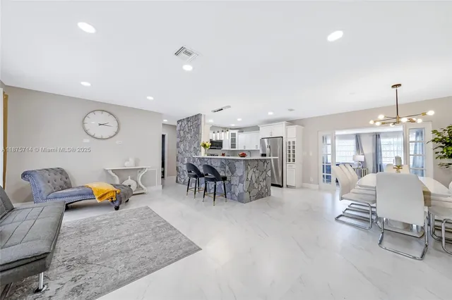 a living room with furniture and kitchen view
