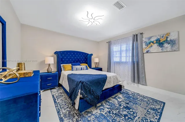 a bed sitting in a bedroom next to a window