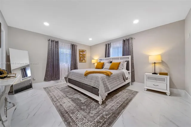 a bedroom with bed and a couch