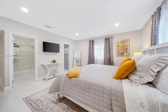 a bedroom with a bed and a couch