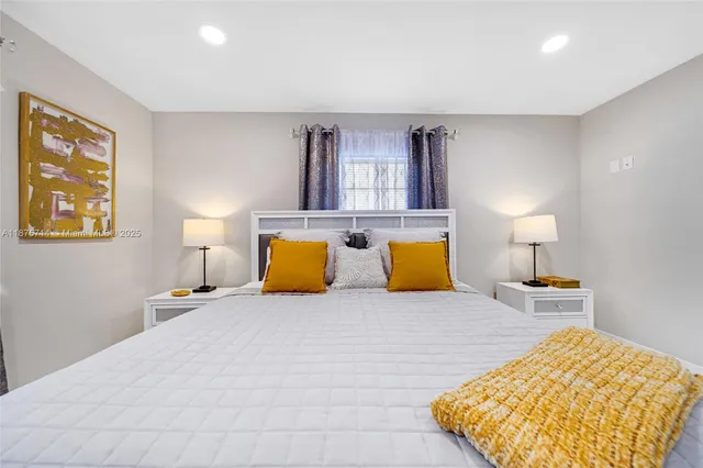 a bedroom with a bed and lamp