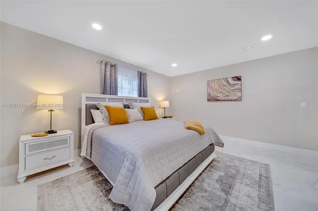 a bedroom with a bed and a lamp