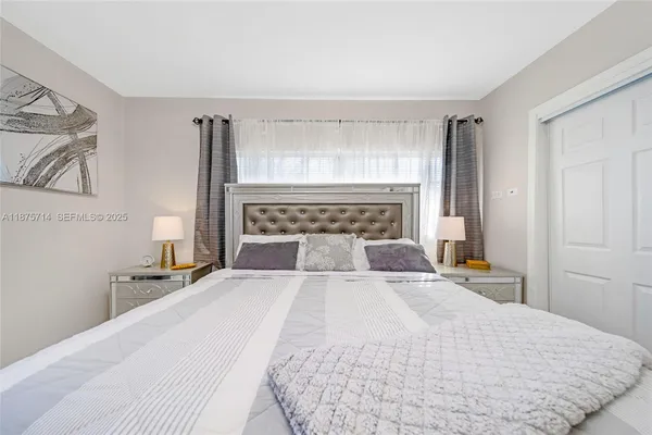 a large white bed in a white room