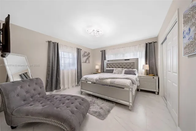 a bedroom with a bed and a couch