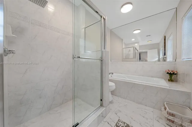 a bathroom with a bathtub and a shower