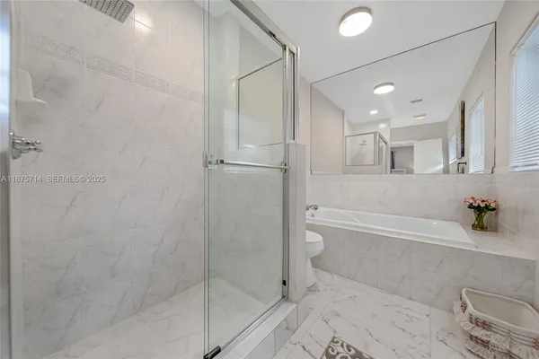 a bathroom with a bathtub and a shower
