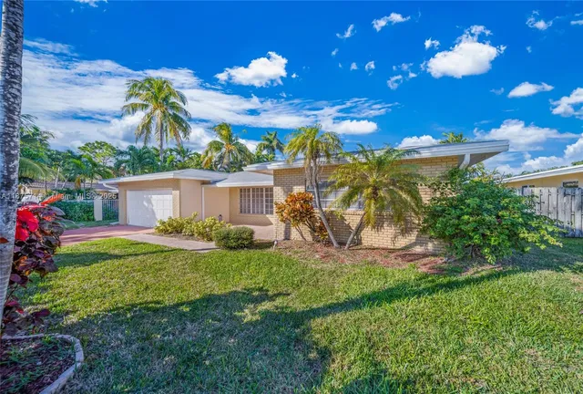 a view of a house with a yard and a garden