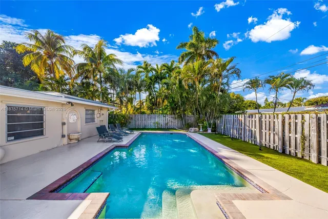 a view of a backyard with swimming pool